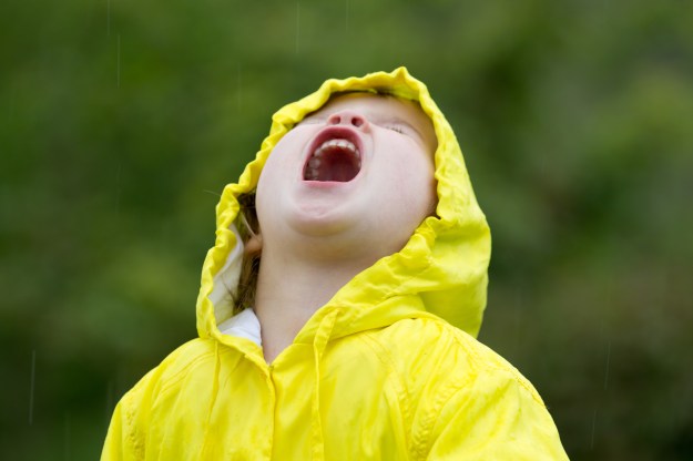 Young girl playing in rain